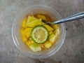 A bowl of healthy fresh fruit salad, made from sliced Ã¢â¬â¹Ã¢â¬â¹pineapple, mango and lime, top view Royalty Free Stock Photo